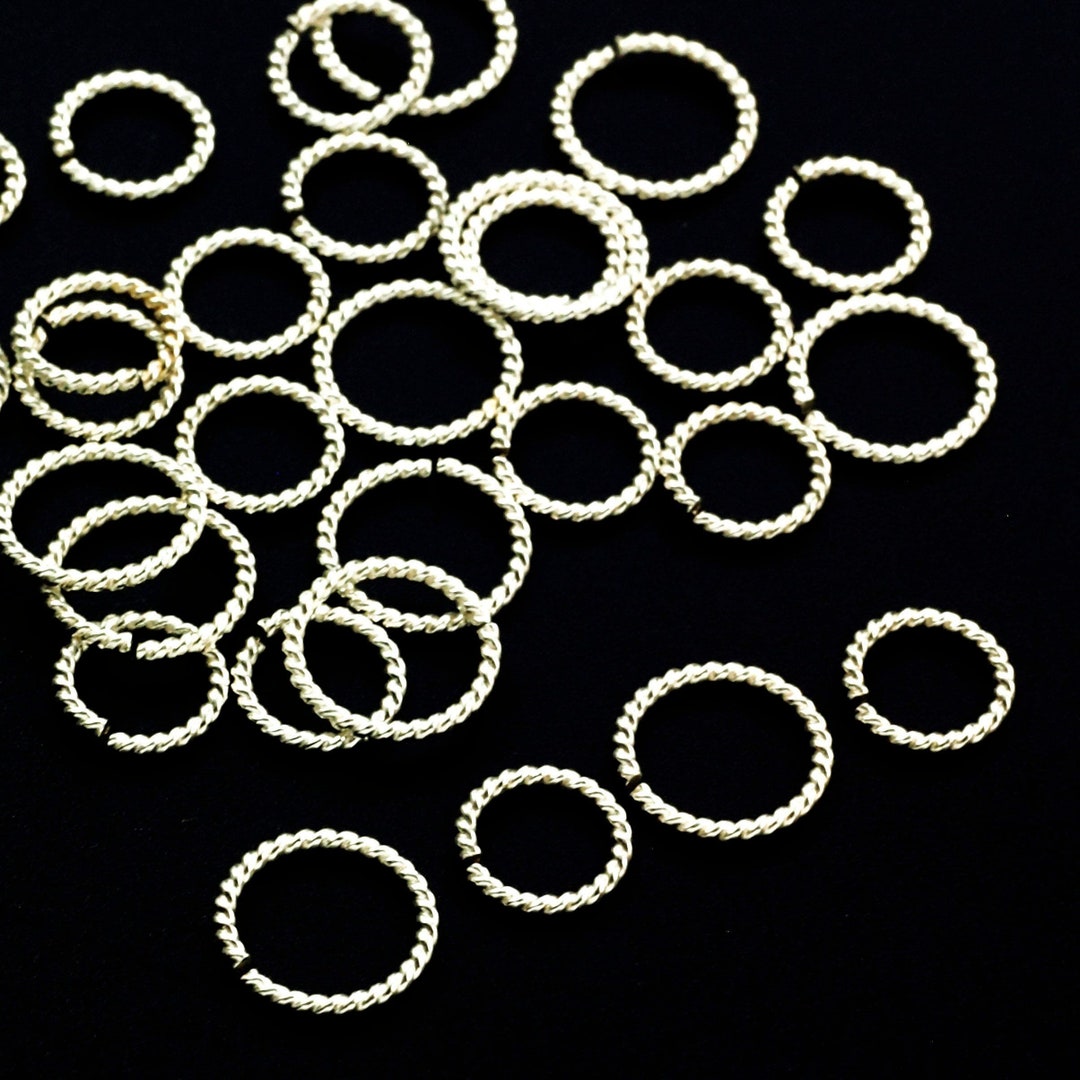 Jump ring, electro-coated brass, black, 6mm round, 4.4mm inside diameter,  20 gauge. Sold per pkg of 50. - Fire Mountain Gems and Beads