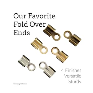 May include: A collection of six metal fold over cord ends in four distinct metallic finishes, including gold, silver, and bronze tones. Each piece features a U-shaped channel for crimping and a circular loop at the end. Text reads: Our Favorite Fold Over Ends, 4 Finishes, Versatile, Sturdy, Creating Unkamen.
