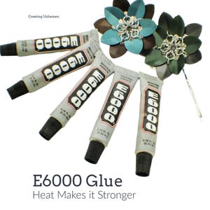 May include: Five tubes of E6000 industrial strength adhesive, each containing 0.18 fluid ounces, arranged in a fan shape next to two decorative metal flower hair pins with teal and dark green petals and silver-toned chainmail centers.