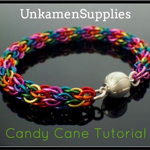May include: A colorful bracelet made of interlocking metal rings in a rainbow of hues. The bracelet has a silver magnetic clasp. The text "UnkamenSupplies" and "Candy Cane Tutorial" are visible in the image.