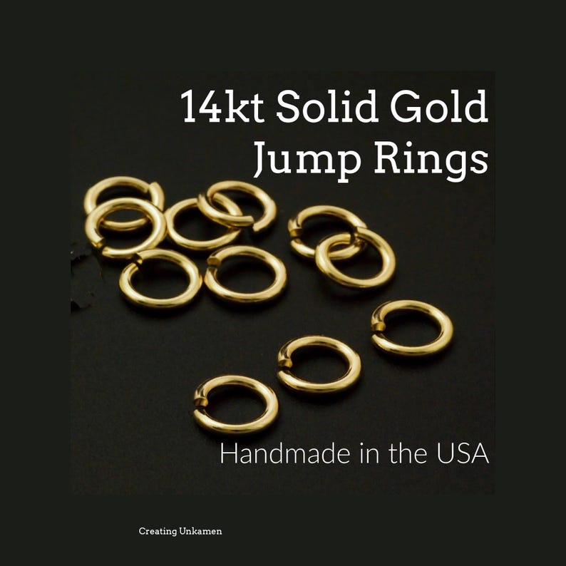 May include: A collection of small, circular 14kt solid gold jump rings with a polished finish. The text 14kt Solid Gold Jump Rings is displayed at the top, and the text Handmade in the USA is at the bottom, with Creating Unkamen at the base.