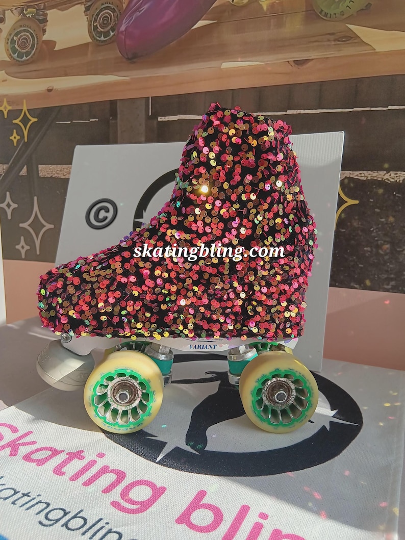 May include: A black roller skate boot with a pink, orange, and green sequin cover. The boot is on a white surface with the text "skatingbling.com" and "VARIANT" on the boot.