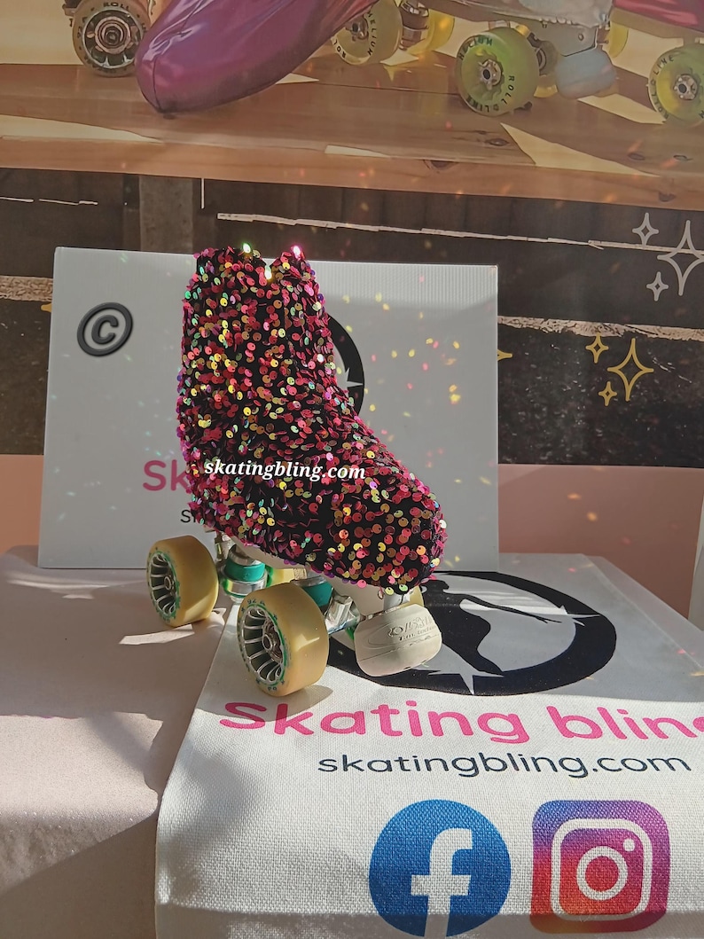 May include: A pair of roller skates with a black and pink sequined boot. The boot has a gold and green wheel and a black and white logo that says "skating bling".
