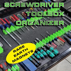 May include: A black toolbox organiser with green dividers holding various screwdrivers. The text "SCREWDRIVER TOOLBOX ORGANIZER" is displayed in green. A yellow oval reads "RARE EARTH MAGNETS".