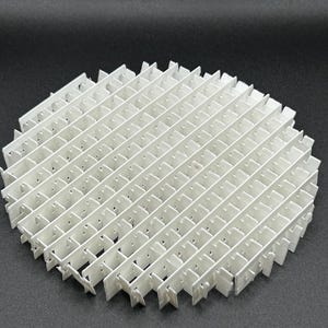 May include: A white, geometric, circular object with a grid-like structure. The object is composed of numerous intersecting rectangular pieces, creating a lattice pattern. The design is symmetrical and appears to be made of a rigid material.