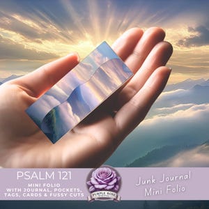 May include: A rectangular mini folio with a landscape design is held in a hand. The folio reflects a mountain and cloud scene. Text on the image reads "PSALM 121 MINI FOLIO" and "Junk Journal Mini Folio". The image also includes the text "WITH JOURNAL, POCKETS, TAGS, CARDS & FUSSY CUTS".