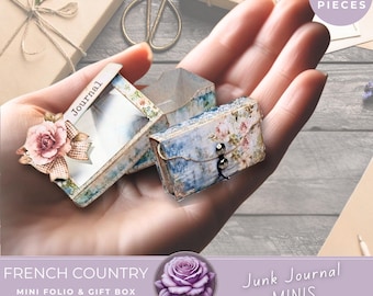 May include: A miniature journal and gift box set with a French country theme. The journal is open, revealing a blank interior, and the gift box is closed with a button clasp. The set is decorated with floral patterns and lace trim. The image also includes the text "90+ PIECES".
