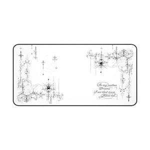 May include: White rectangular desk mat with a black border. The mat features a black and white abstract design with the text "In my restless dreams I see that town Silent hill."