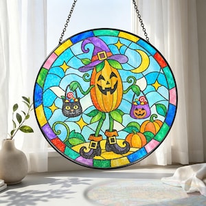 May include: A circular stained glass suncatcher featuring a central orange jack-o'-lantern character wearing a purple witch hat and black boots. The figure holds two small treat buckets, one shaped like a black cat and one like a pumpkin.