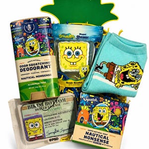 May include: A collection of Spongebob Squarepants themed items including a 2.65 oz deodorant stick, a 3.5 oz shower steamer, a pair of light blue socks with a Spongebob graphic, a Spongebob driver license card, and a 5 oz bar of natural soap.