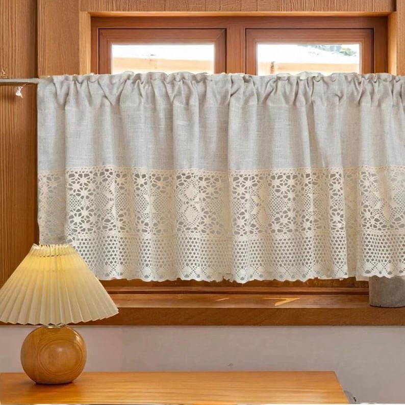 Victorian white cotton cafe curtain with ruffled valance and shabby chic lace trim, hung on a rustic window for French Country kitchens