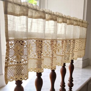Victorian white cotton cafe curtain with ruffled valance and shabby chic lace trim, hung on a rustic window for French Country kitchens