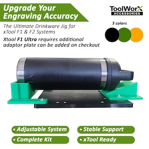 May include: A black drinkware jig with green supports, designed for xTool F1 & F2 systems. The jig includes the text "Upgrade Your Engraving Accuracy" and "ToolWorx Accessories". It features an adjustable system and stable support, and is xTool ready.