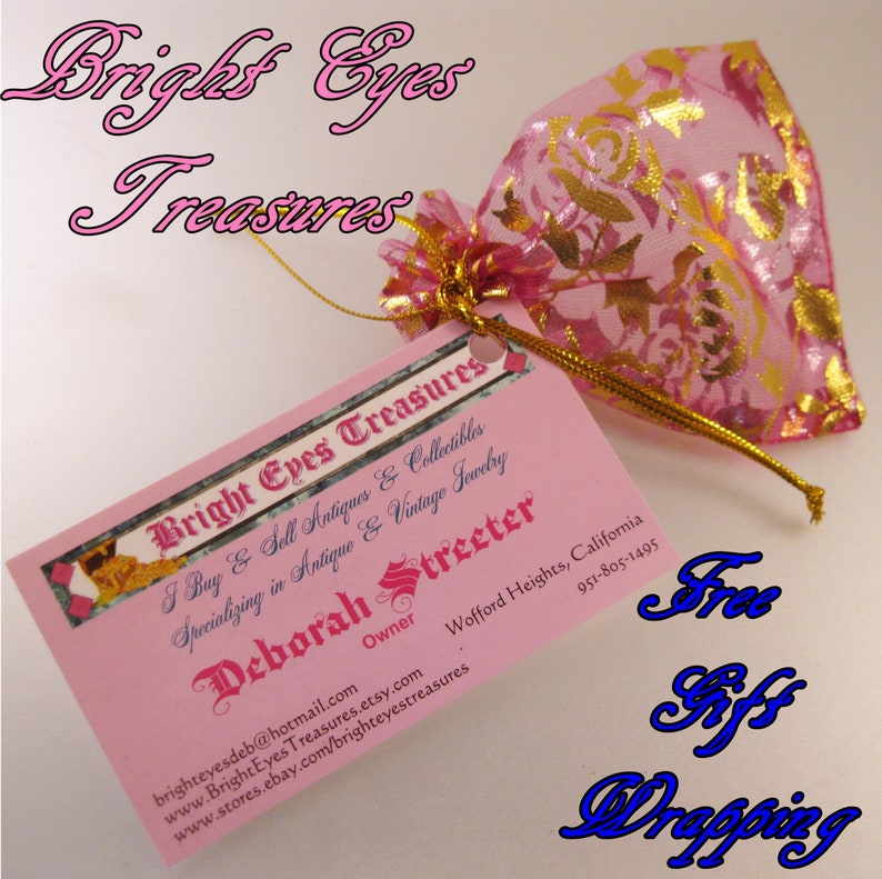 May include: A pink business card with gold lettering that reads "Bright Eyes Treasures" and includes the owner's name, contact information, and a description of the business. The card is attached to a pink and gold drawstring bag.