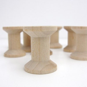 12 Wooden spools 1 1/8" tall