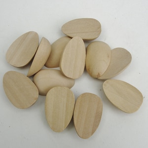 May include: A group of 11 unfinished wooden egg shapes, ideal for crafting and DIY projects.
