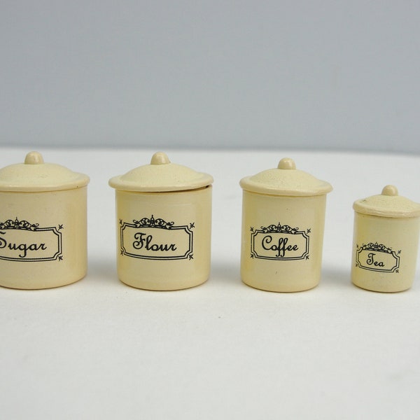 Miniature canister set labeled flour sugar coffee tea