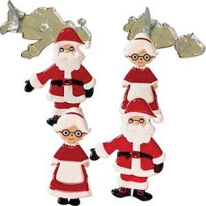 May include: Set of four cookie cutters, two red and white Santa Claus figures and two red and white Mrs. Claus figures. The cutters are made of metal and have a shiny silver finish.