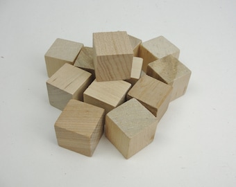 May include: A pile of ten unfinished wooden cubes, all the same size, in various positions.
