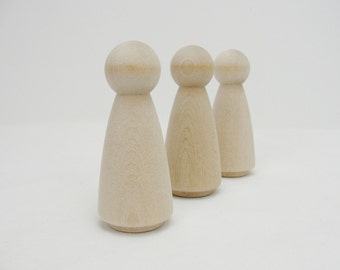 May include: Three unfinished wooden peg dolls with rounded heads and conical bodies. The dolls are made of light-colored wood and stand on a white background. These dolls are perfect for crafting and DIY projects.