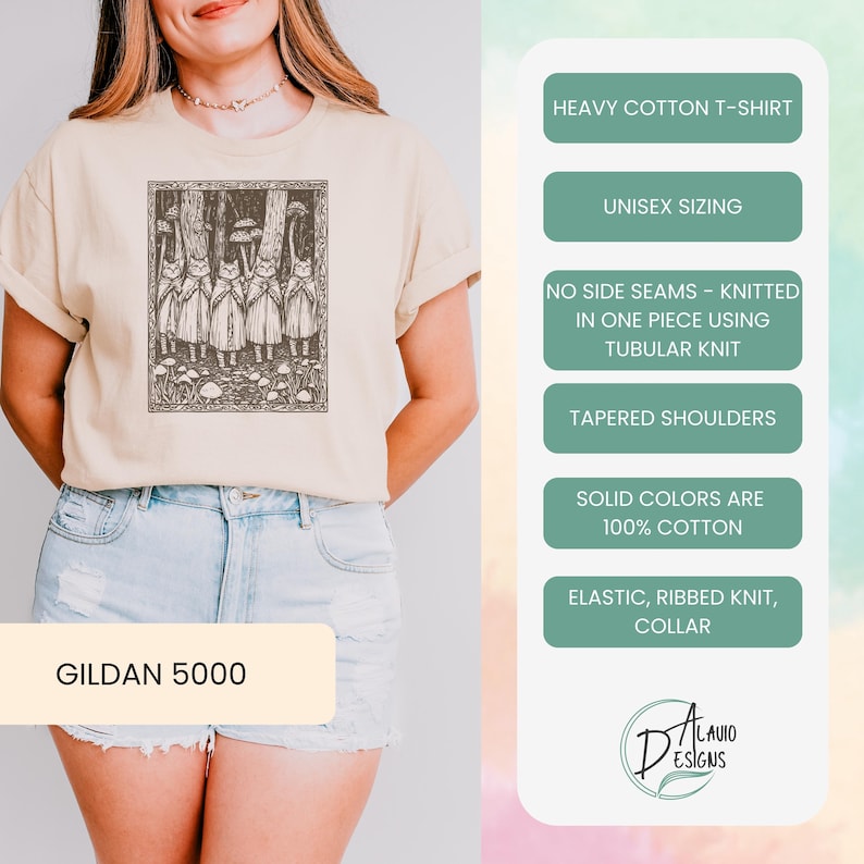 May include: A beige t-shirt with a black and white illustration of a group of figures in a forest. The shirt is made of heavy cotton and has a unisex fit. The text "GILDAN 5000" is printed on the bottom of the shirt. The text "HEAVY COTTON T-SHIRT", "UNISEX SIZING", "NO SIDE SEAMS - KNITTED IN ONE PIECE USING TUBULAR KNIT", "TAPERED SHOULDERS", "SOLID COLORS ARE 100% COTTON", "ELASTIC, RIBBED KNIT, COLLAR", and "LAVIO DESIGNS" is printed on the right side of the image.