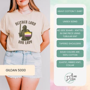 May include: A beige Gildan 5000 t-shirt with the text "Neither Lord Nor Lady" and a knight graphic holding a sword and shield with non-binary flag colors. Features include unisex sizing, tapered shoulders, and a ribbed knit collar.