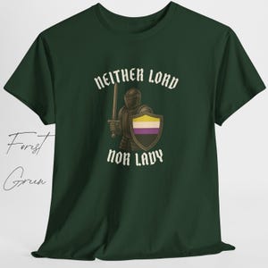 May include: Forest green t-shirt with the text "Neither Lord Nor Lady" in white gothic font. The graphic features a knight holding a sword and shield with the non-binary pride flag colors. The shirt is made of a soft material.