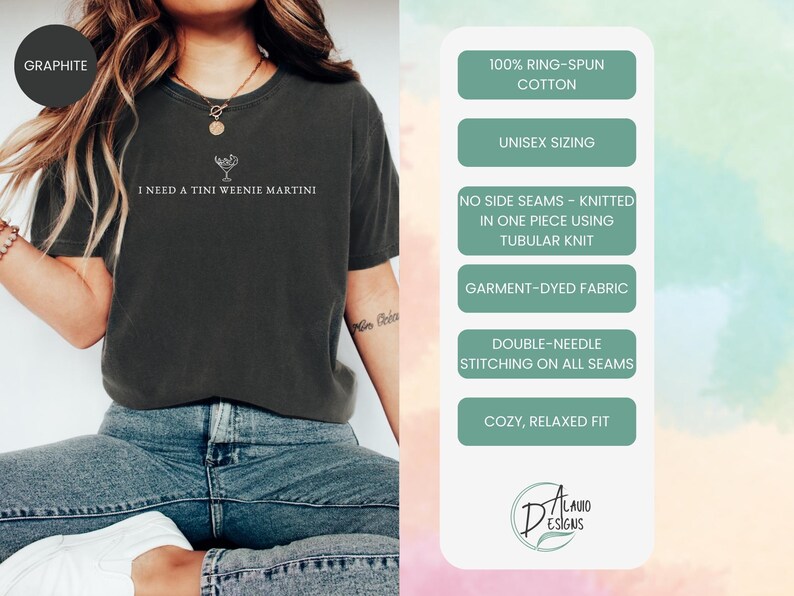 May include: Graphite-coloured t-shirt with the text "I NEED A TINI WEENIE MARTINI" and a martini glass graphic. Features include 100% ring-spun cotton, unisex sizing, no side seams, garment-dyed fabric, double-needle stitching, and a cosy, relaxed fit.