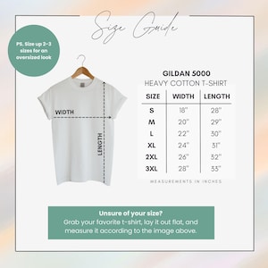 May include: A white Gildan 5000 heavy cotton t-shirt hanging on a wooden hanger. The image includes a size guide with measurements in inches for sizes S to 3XL. Text on the image reads, "Size Guide" and "Unsure of your size?"