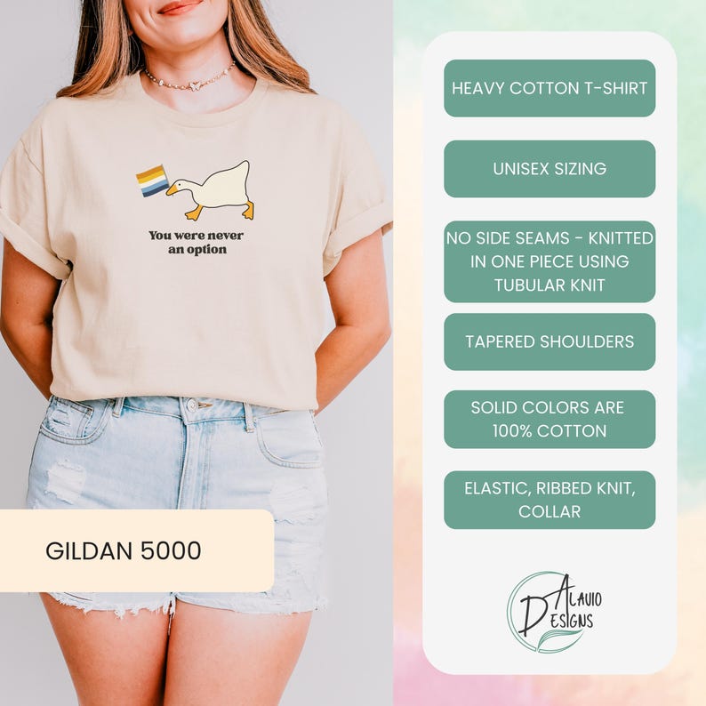 Op de afbeelding: Een beige T-shirt met een witte eend die een regenboogvlag vasthoudt en de tekst "You were never an option". Het shirt is een Gildan 5000, een zwaar katoenen T-shirt met unisex maatvoering, zonder zijnaden, gebreid met een buisvormige constructie, taps toelopende schouders en een elastische geribbelde kraag.