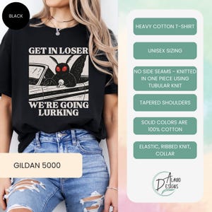 May include: Black Gildan 5000 heavy cotton t-shirt with a graphic of a moth driving a car, with the text "GET IN LOSER WE'RE GOING LURKING". Features unisex sizing, no side seams, tapered shoulders, and an elastic ribbed knit collar.