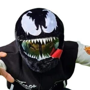 May include: A black Venom mask with white eye accents and sharp white teeth. The mask has a green tinted visor and a red tongue. The person is wearing a black hoodie with white sleeves and a logo on the front.