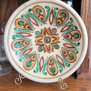 May include: A set of three ceramic mugs with a speckled, matte finish. The mugs are in shades of cream, light gray, and dark gray. Each mug has a simple, minimalist design and a rounded handle. Perfect for coffee or tea.