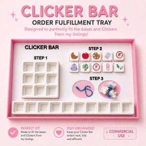 May include: A pink rectangular order fulfillment tray labeled CLICKER BAR. It contains a white nine-grid square tray, a ten-slot rectangular tray, and sections for small square clicker pieces with various icons, a blue ball chain, and small components.