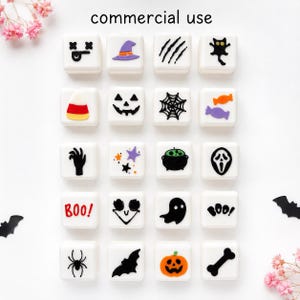 May include: A set of twenty square white tiles featuring various Halloween-themed icons including a witch hat, spider web, ghost, pumpkin, candy corn, and the text "BOO". Each tile displays a distinct black, orange, or purple graphic design.