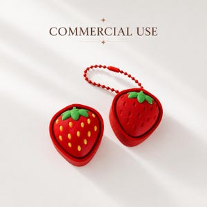 May include: Two strawberry-shaped items, one with a red ball chain attached. The strawberries are red with green leaves and yellow seeds. The text COMMERCIAL USE is centered above the items. The design is consistent across both pieces.