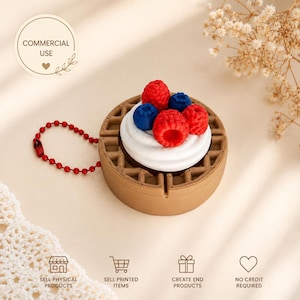 May include: A round, tan, waffle-textured container topped with white cream, two red raspberries, and two blue blueberries. A red ball chain is attached to the side. The item features text reading COMMERCIAL USE, SELL PHYSICAL PRODUCTS, SELL PRINTED ITEMS, CREATE END PRODUCTS, and NO CREDIT REQUIRED.