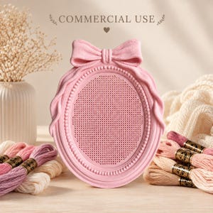 May include: An oval pink frame with a bow at the top and a perforated center panel. The frame features a beaded inner border and a textured outer edge. The text "COMMERCIAL USE" is printed above the frame, accompanied by a small heart icon.