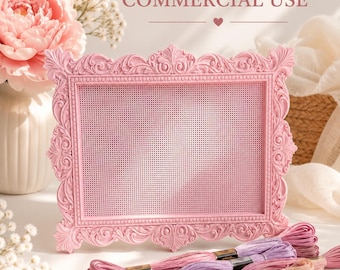 May include: A rectangular pink frame with an ornate, carved border and a grid-patterned center insert. The text "COMMERCIAL USE" is printed above the frame. Several skeins of embroidery floss in shades of pink and purple lie in the foreground.