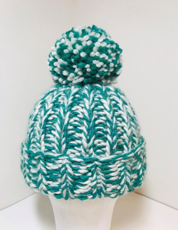 green and white bobble hat