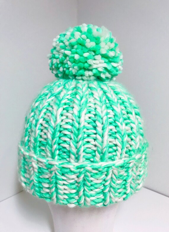 green and white bobble hat