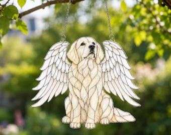 May include: A stained glass suncatcher featuring a cream-coloured dog with large white feathered wings. The dog is depicted in a sitting position with a detailed leaded glass pattern. It hangs from two silver-toned metal chains attached to the top.