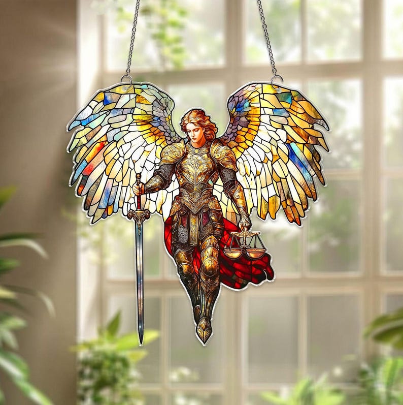 May include: A stained glass angel with outstretched wings, holding a sword and scales. The angel is clad in golden armor and a red cloak. The wings are a mosaic of yellow, blue, and white glass, suspended by a chain.