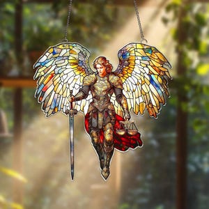 May include: Stained glass angel with outstretched wings, holding a sword and scales. The angel is clad in golden armor and a red cape. The wings are a mosaic of colorful glass pieces, suspended by a chain.