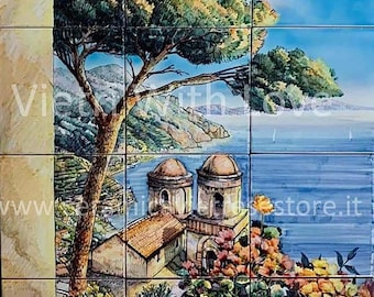May include: A colorful ceramic tile mural depicting a coastal scene with a building, a pine tree, and a blue sea with sailboats. The building has two domes and is surrounded by flowers. The tile mural is made up of nine individual tiles.