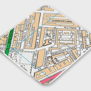 May include: A black and white map of a city with street names and a school and police station marked. The map is in a diamond shape.