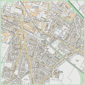 May include: A detailed street map of a town, showing roads, buildings, and points of interest. The map is in a beige and white color scheme with black text, including street names and landmarks. The map is framed by a green border.