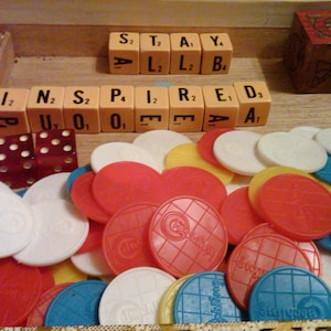 SALE. Lot of old game pieces in wooden cigar box. over 100 total pieces. lucite dice, marble, poker chips, blocks, scrabble cubes.