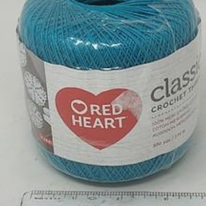 May include: A ball of teal-colored Red Heart Classic Crochet Thread. The label features a red heart logo and the text "Classic Crochet Thread". The ball contains 500 yards of thread.