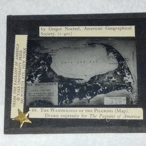 May include: A black and white map of Cape Cod Bay, titled "The Wanderings of the Pilgrims," framed in black. The map includes text about the Mayflower and the final landing in Plymouth. A gold star and text from "The Pageant of America" are also visible.